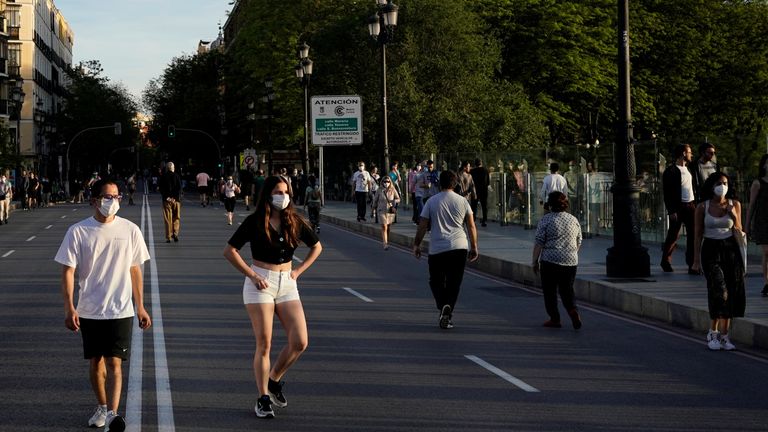 People wearing face masks walk along a street, as the spread of the coronavirus disease (COVID-19) continues, in Madrid, Spain, May 3, 2020