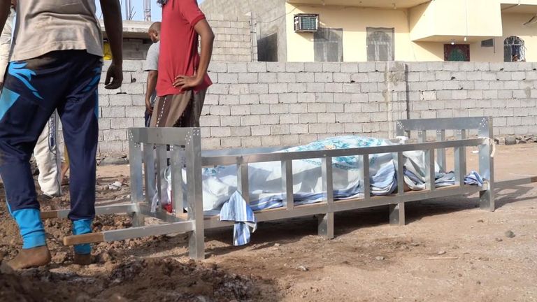 A body is brought to Radhwan cemetery for burial