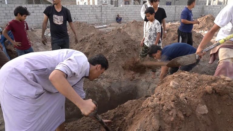 Men dig the graces by hand at Radhwan cemetery