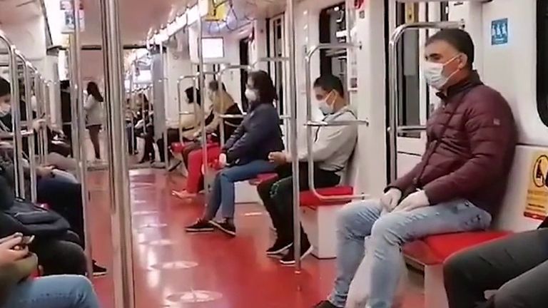 Commuters stay apart on the Milan metro
