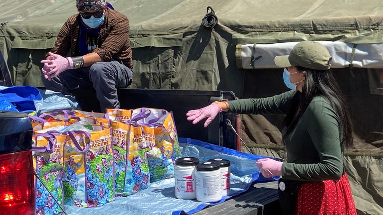 Relief workers load supplies for Navajo families quarantined in their homes