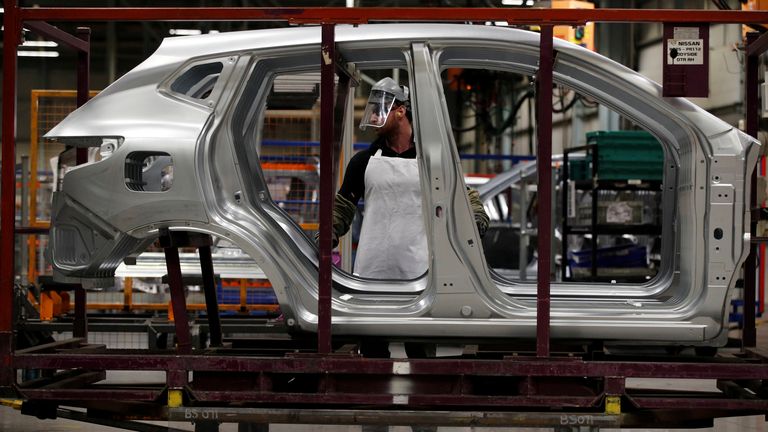 Workers are seen on the production line at Nissan&#39;s car plant in Sunderland 