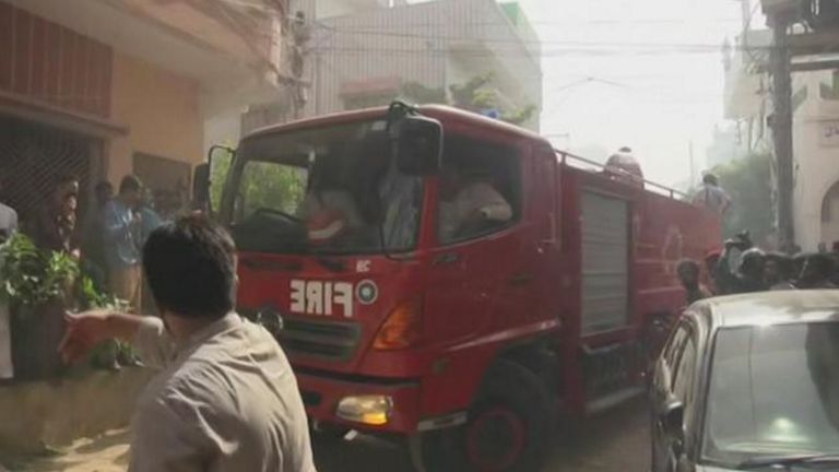 Fire crews rushed to the scene and a man is seen directing them through the crowds. Pic: APTN Direct