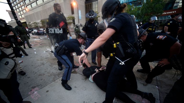 Police officers and protesters clash near CNN center, Friday, May 29, 2020 in Atlanta. The protest started peacefully earlier in the day before demonstrators clashed with police. (AP Photo/Mike Stewart)