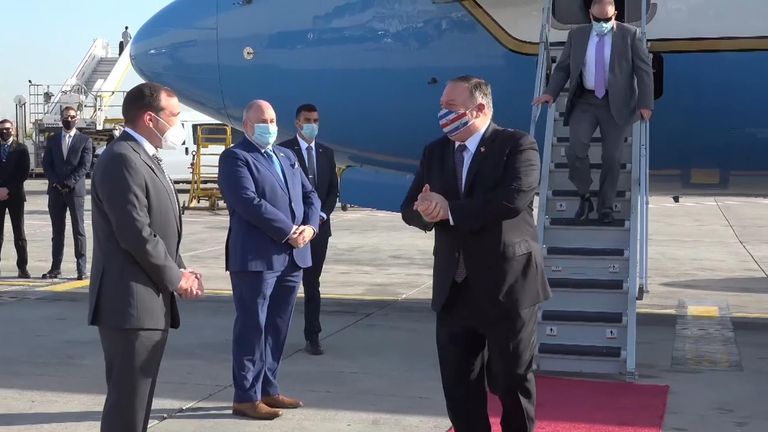 US Secretary of State Mike Pompeo with face mask getting off plane and being greeted by officials in Israel
