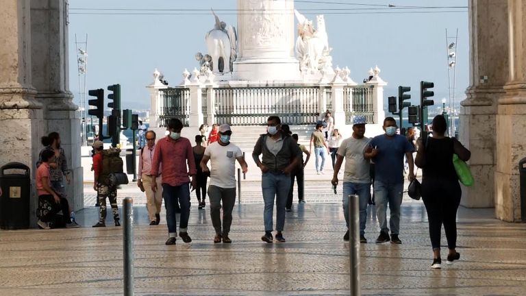 People wear masks in Lisbon, Portugal