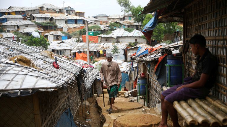 A Rohingya refugee walks through a camp in Cox&#39;s Bazar, Bangladesh