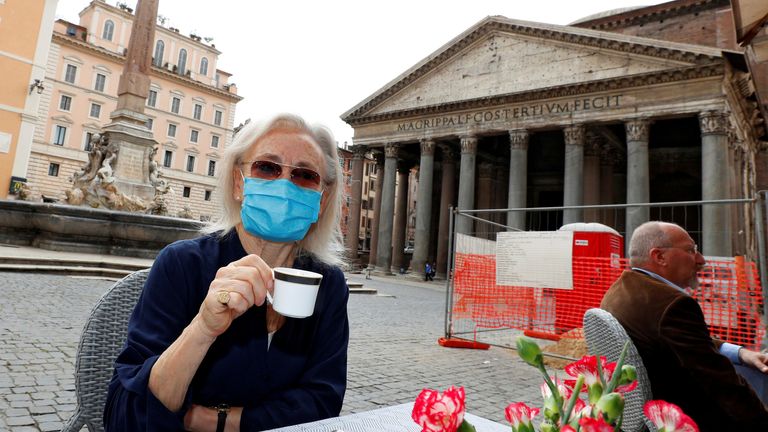 A woman enjoys a drink at a restaurant near the Pantheon,  Rome