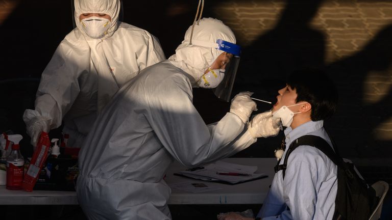 A health worker administers a swab at a temporary coronavirus testing centre in Bucheon, south of Seoul