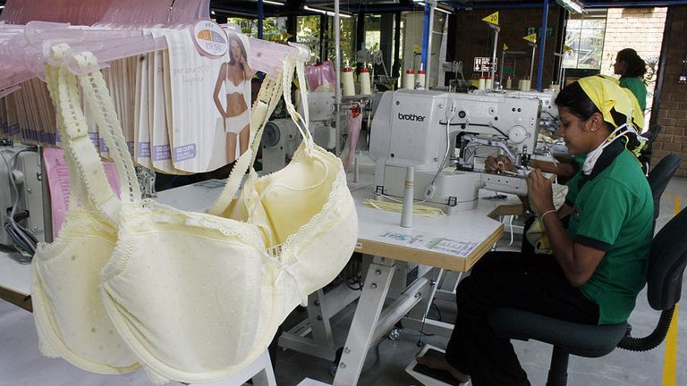 A Sri Lankan factory worker attached to clothing manufacturer Marks and Spencer Group, puts the finishing touches to a brassiere at a newly opened eco-friendly plant which stitches lingerie in Thulhiriya, some 60kms south of Colombo on April 25, 2008. The plant was opened by Marks and Spencer&#39;s chief executive Sir Stuart Rose. MAS, one of Sri Lanka&#39;s biggest lingerie exporters, has built the factory on stilts and is using vegetation, solar energy and rainwater harvesting to run their production 