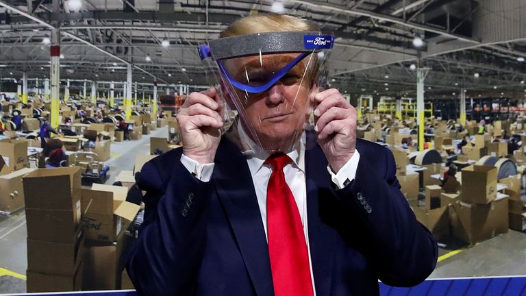 Donald Trump did pose with a transparent visor, but did not wear a mask