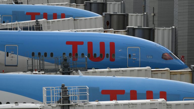 Aircraft grounded due to the COVID-19 pandemic, including planes operated by TUI are pictured on the apron at Manchester Airport in Manchester, north west England on May 1, 2020