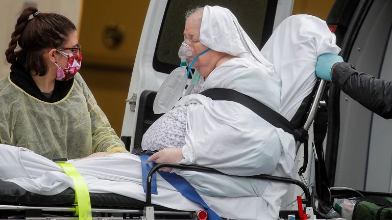 Paramedics unload a patient at a hospital in Brooklyn