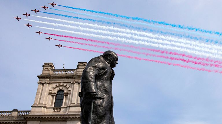 The Red Arrows fly over the statue of Winston Churchill in London