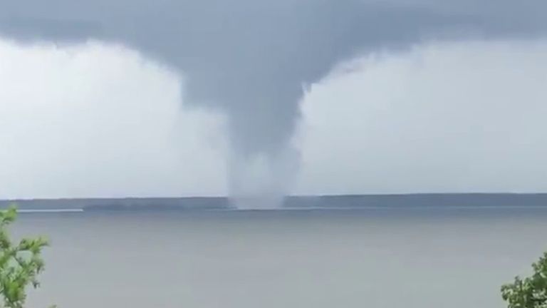 People observe a fine example of a waterspout in Texas