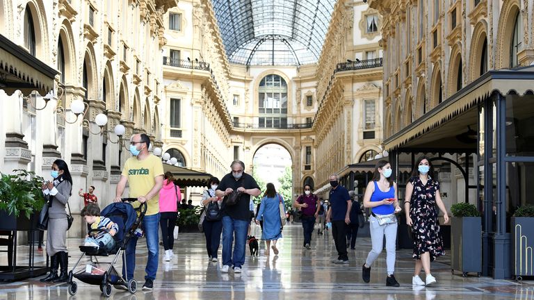 FILE PHOTO: People walk at at Galleria Vittorio Emanuele II, as Italy eases some of the lockdown measures put in place during the coronavirus disease (COVID-19) outbreak, in Milan, Italy May 18, 2020. REUTERS/Flavio Lo Scalzo/File Photo
