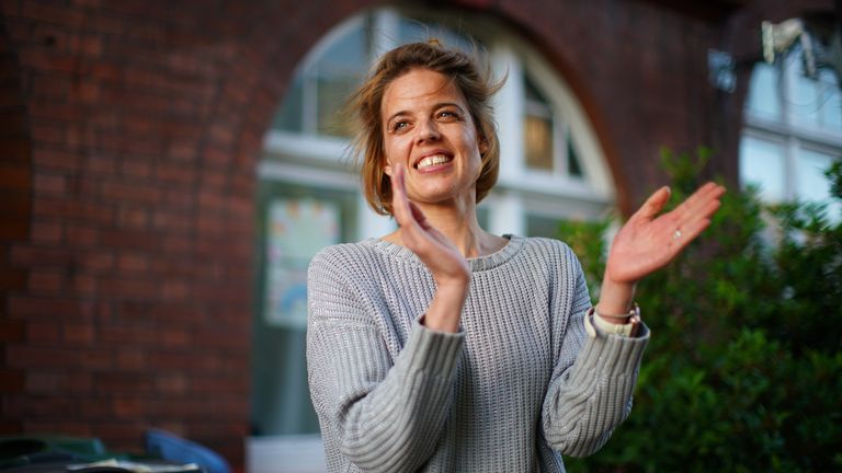 Annemarie Plas, 36, a Dutch national living in south London who created the weekly 8pm Clap For Our Carers, stands with other residents in south London, as she joins the applause to salute local heroes during Thursday&#39;s nationwide Clap for Carers to recognise and support NHS workers and carers fighting the coronavirus pandemic.