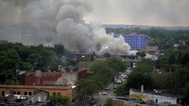 Plumes of smoke rise into the sky in the aftermath of a protest after a white police officer was caught on a bystander&#39;s video pressing his knee into the neck of African-American man George Floyd, who later died at a hospital, in Minneapolis, Minnesota, U.S., May 29, 2020. REUTERS/Carlos Barria TPX IMAGES OF THE DAY
