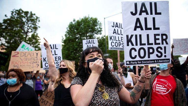 Protesters hold signs during a protest against the fatal injury inflicted by Minneapolis police on African-American man George Floyd, in Denver, Colorado, U.S. May 28, 2020. Picture taken May 28, 2020. REUTERS/Alyson McClaran
