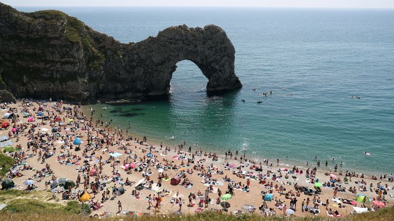 People enjoying the good weather on the beach at Durdle Door, near Lulworth in Dorset, as the public are being reminded to practice social distancing following the relaxation of lockdown restrictions.
