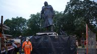 Workers finish taking down boarding and scaffolding around the Winston Churchill statue 