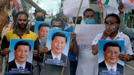Indian activists hold posters and effigy of Chinese President Xi Jinping during an anti-China protest