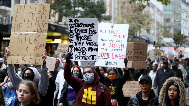 AUCKLAND, NEW ZEALAND - JUNE 01: Protestors march down Queen Street on June 01, 2020 in Auckland, New Zealand. The rally was organised in solidarity with protests across the United States following the killing of an unarmed black man George Floyd at the hands of a police officer in Minneapolis, Minnesota.  (Photo by Hannah Peters/Getty Images)