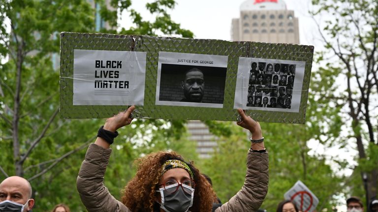 A woman is holding a Black Lives Matter placard asking for Justice for George and other victims of racism and police brutalities on Montreal's Place du Canada on May 31, 2020. - Several thousands demonstrators marched on Sunday in central Montreal against racism and police violence, in solidarity with demonstrations in the United States following the death of George Floyd. (Photo by Eric THOMAS / AFP) (Photo by ERIC THOMAS/AFP via Getty Images)