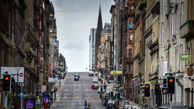 GLASGOW, SCOTLAND - MARCH 21: Members of the public cross St Vincent Street on March 21, 2020 in Glasgow, Scotland. Coronavirus (COVID-19) has spread to at least 182 countries, claiming over 10,000 lives and infecting more than 250,000 people. There have now been 3,269 diagnosed cases in the UK and 144 deaths.  (Photo by Jeff J Mitchell/Getty Images)
