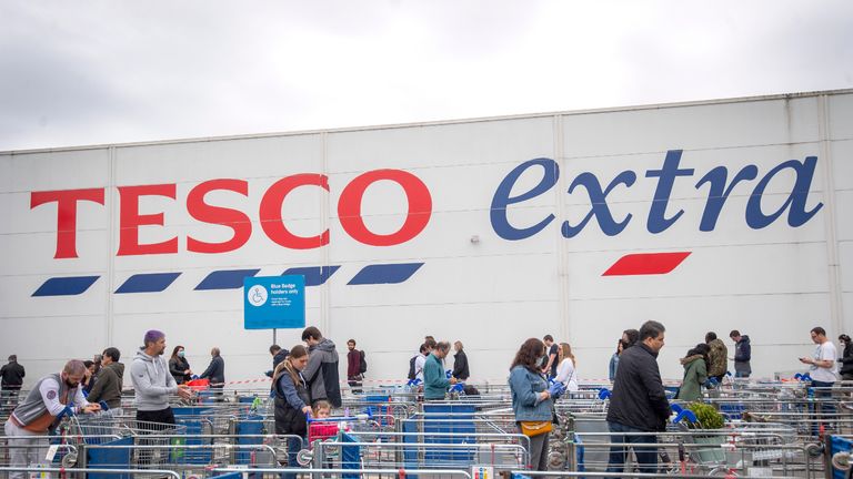 A long queue maintaining social distancing outside a Tesco supermarket in north London as the UK continues in lockdown to help curb the spread of the coronavirus.