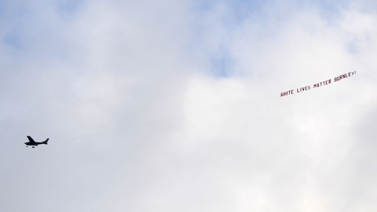 A plane flies over the stadium with a banner reading 'White Lives Matter Burnley' during the Premier League match at the Etihad Stadium, Manchester.