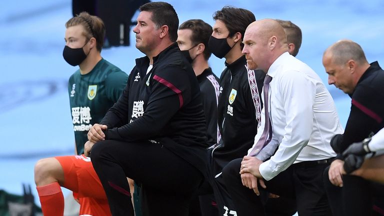Burnley&#39;s English manager Sean Dyche (2R) takes a knee in support of the Black Lives Matter movement ahead of the English Premier League football match between Manchester City and Burnley at the Etihad Stadium in Manchester, north west England, on June 22, 2020. (Photo by Michael Regan / POOL / AFP) / RESTRICTED TO EDITORIAL USE. No use with unauthorized audio, video, data, fixture lists, club/league logos or &#39;live&#39; services. Online in-match use limited to 120 images. An additional 40 images may be used in extra time. No video emulation. Social media in-match use limited to 120 images. An additional 40 images may be used in extra time. No use in betting publications, games or single club/league/player publications. /  (Photo by MICHAEL REGAN/POOL/AFP via Getty Images)