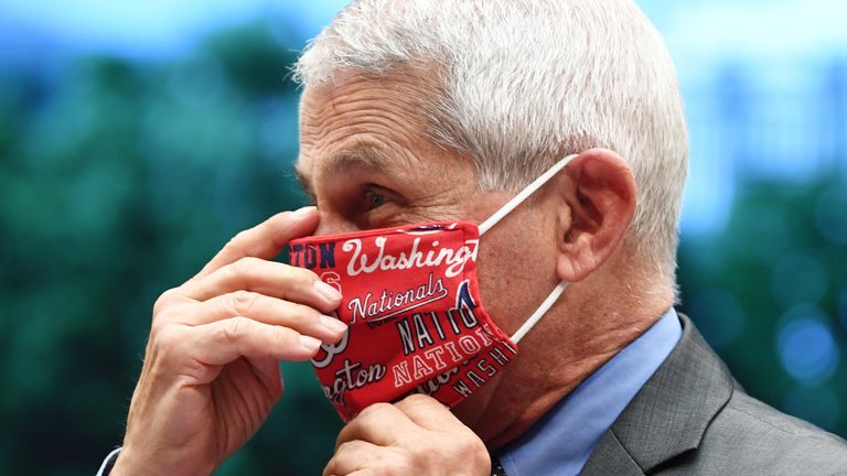 WASHINGTON, DC - JUNE 23:  Dr. Anthony Fauci, director of the National Institute for Allergy and Infectious Diseases, dons a face mask bearing the name of the Major League Baseball Washington Nationals before a hearing of the House Committee on Energy and Commerce on Capitol Hill on June 23, 2020 in Washington, DC. The committee is investigating the Trump administration's response to the COVID-19 pandemic.  (Photo by Kevin Dietsch-Pool/Getty Images)