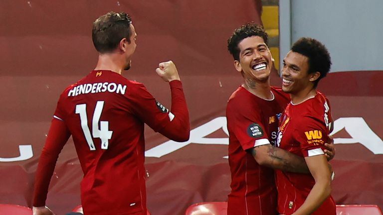 Liverpool's English defender Trent Alexander-Arnold (R) celebrates scoring the opening goal with Liverpool's Brazilian midfielder Roberto Firmino (C) and Liverpool's English midfielder Jordan Henderson during the English Premier League football match between Liverpool and Crystal Palace at Anfield in Liverpool, north west England on June 24, 2020. (Photo by PHIL NOBLE / POOL / AFP) / RESTRICTED TO EDITORIAL USE. No use with unauthorized audio, video, data, fixture lists, club/league logos or 'live' services. Online in-match use limited to 120 images. An additional 40 images may be used in extra time. No video emulation. Social media in-match use limited to 120 images. An additional 40 images may be used in extra time. No use in betting publications, games or single club/league/player publications. /  (Photo by PHIL NOBLE/POOL/AFP via Getty Images)