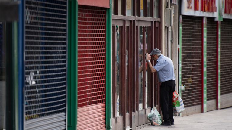 CARDIFF, UNITED KINGDOM - MAY 21: A man looks in the window of a closed coffee shop during the coronavirus lockdown period on May 21, 2020 in Cardiff, United Kingdom. The British government has started easing the lockdown it imposed two months ago to curb the spread of Covid-19, abandoning its 'stay at home' slogan in favour of a message to 'be alert', but UK countries have varied in their approaches to relaxing quarantine measures. (Photo by Matthew Horwood/Getty Images)