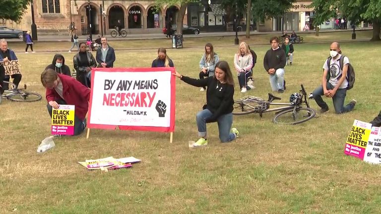 Demonstrators kneeled down and held Black Lives Matter signs in Bristol