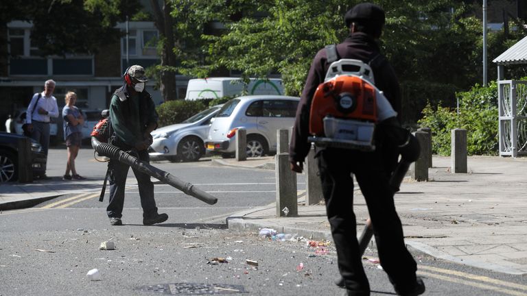 Volunteers helped clean up the road after party goers threw bottles and threatened police