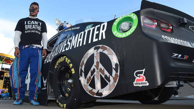 Bubba Wallace wears a "I Can&#39;t Breathe - Black Lives Matter" t-shirt under his fire suit in solidarity with protesters around the world taking to the streets after the death of George Floyd