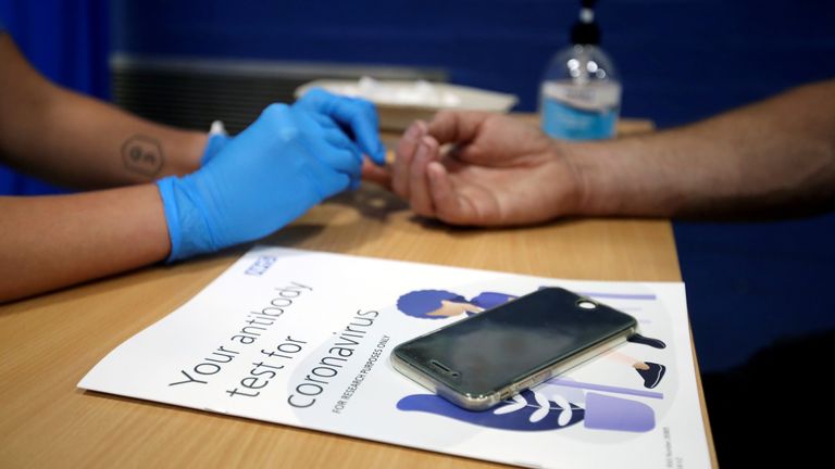 A man has his finger pricked during a clinical trial of tests for the coronavirus disease (COVID-19) antibodies, at Keele University, in Keele, Britain June 30, 2020. REUTERS/Carl Recine