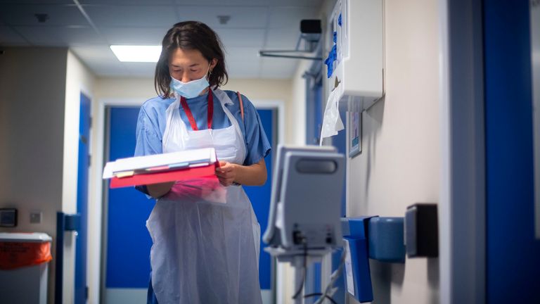 A doctor checks on patient notes. File pic