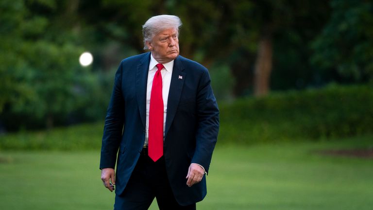 Donald Trump walks to the White House residence after exiting Marine One