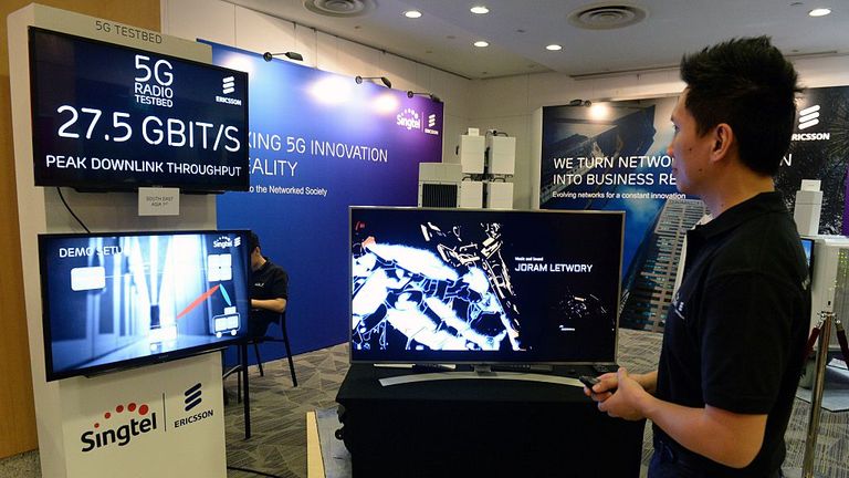 A staff member demonstrates video streaming at the maximum 27.5 bigabits per second peak downlink throughput connecting to a 5G radio testbed in Singapore on August 2, 2016. SingTel and Ericsson, the Swedish maker of wireless networking equipment, have teamed up to harness the potential of 5G technology in Southeast Asia. / AFP / ROSLAN RAHMAN (Photo credit should read ROSLAN RAHMAN/AFP via Getty Images)
