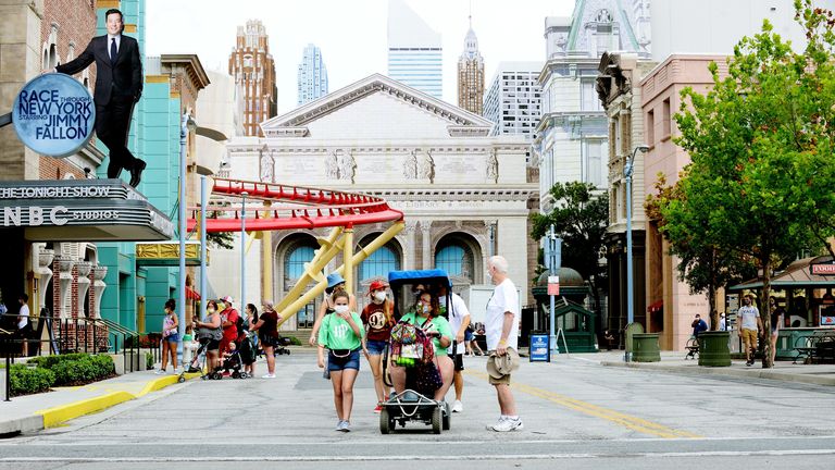 ORLANDO, FLORIDA - JUNE 05: Visitors attend the Universal Studios theme park first day of reopening from the coronavirus pandemic at Universal Orlando Resort on June 05, 2020 in Orlando, Florida. (Photo by Gerardo Mora/Getty Images,)