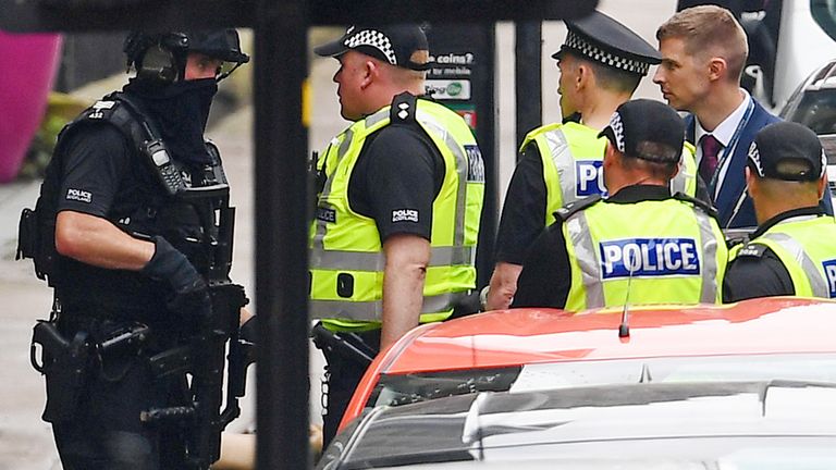 GLASGOW, SCOTLAND - JUNE 26: An armed police officer speaks with his colleagues in front of a cordoned off area after reports of three people being killed in a central Glasgow hotel on June 26, 2020 in Glasgow, Scotland. A knifeman stabbed three people to death in the stairwell of the Park Inn Hotel on West George Street, Glasgow before being shot himself by armed police. The Scottish Police Federation (SPF) said an officer was stabbed during the major incident. (Photo by Jeff J Mitchell/Getty Images)