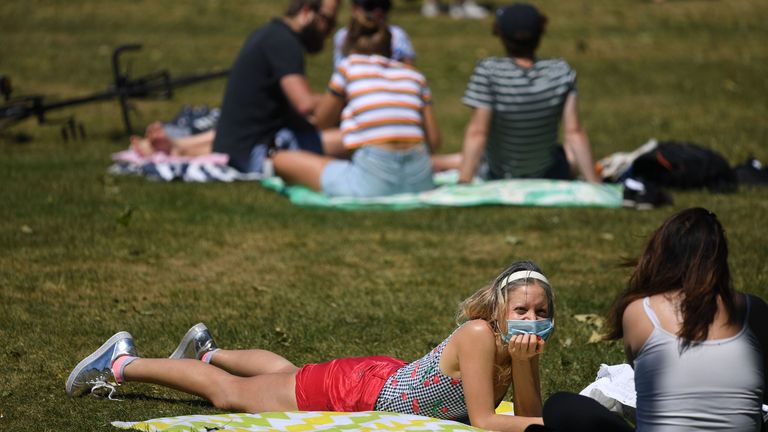 People enjoy the sunshine at St James Park in central London