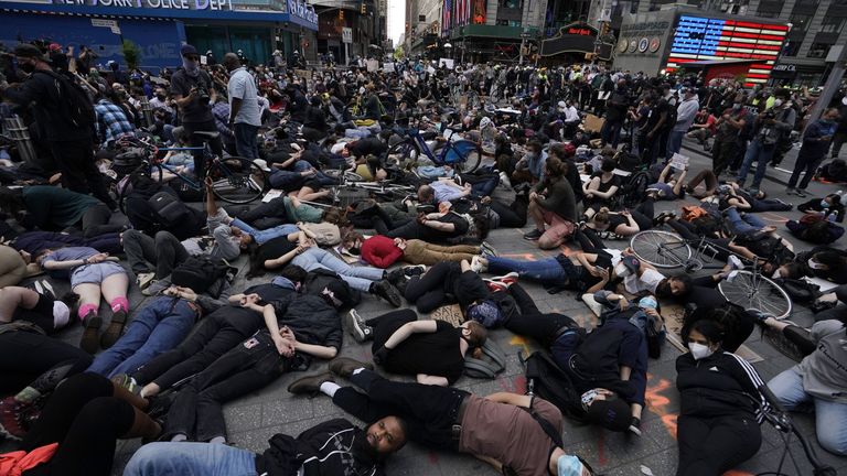 Protesters in Times Square lay on the ground with their hands behind their back in a call for justice for George Floyd