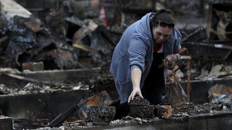 22 November 2018: Brandy Powell looks picks through the remains of her home in Paradise 