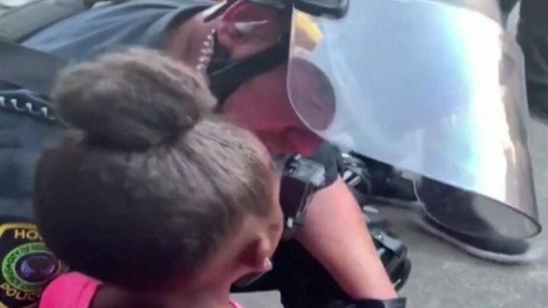 U.S. police officer hugs crying girl asking "are you going to shoot us"