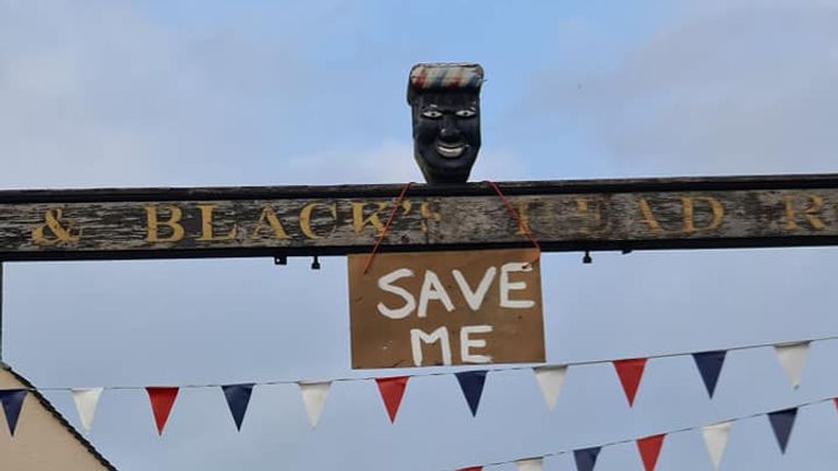 A sign saying 'Save Me' was seen hanging on a sign for the Greenman pub in Ashbourne, Derbyshire, before the head was removed