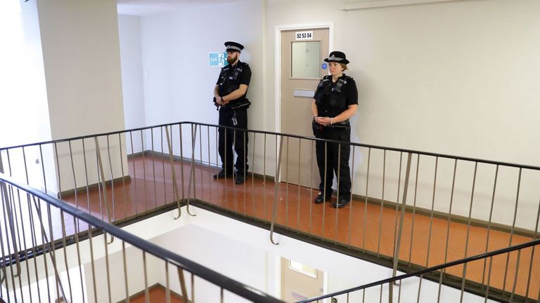 Officers stood guard outside the entrance to the corridor where Saadhalla&#39;s flat is believed to be